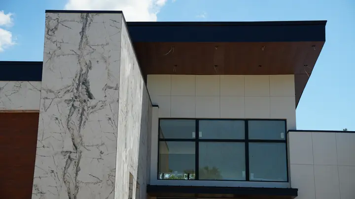 Upper facade with wood-look soffit under dark fascia