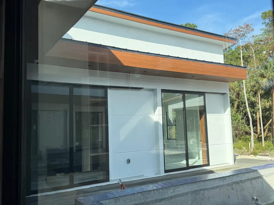South Florida residence with wood-look metal cladding and aluminum soffit